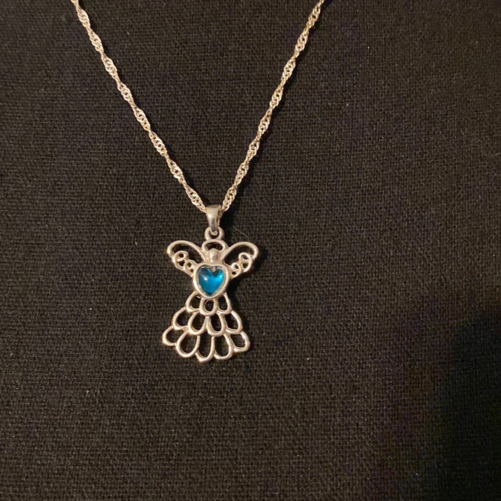 New in box Avon December birthstone Angel necklace with a bonus pin